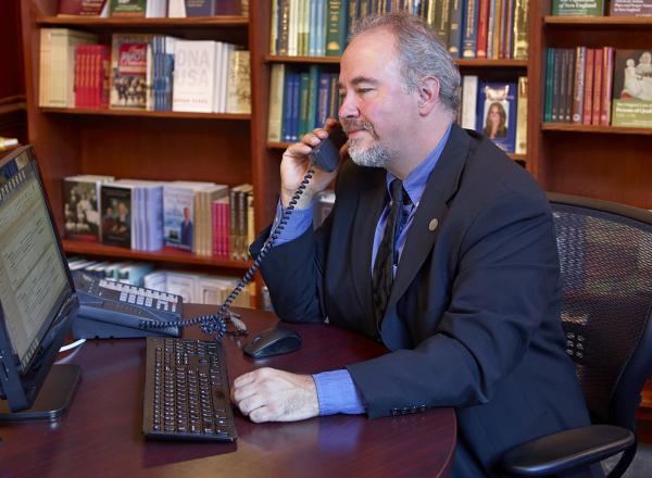 David Allen Lambert takes phone call at desk