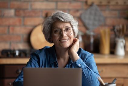 What's New at American Ancestors 3-2024 older woman at a laptop
