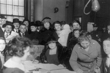 Men and women at voting poll, Oliver and Henry Streets, New York City