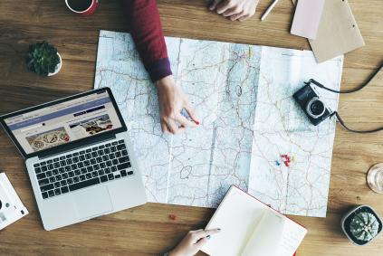 woman putting a pin on a map